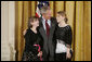 President George W. Bush congratulates eighth grade students of 2004 from Grant Community Middle School in Salem, Ore., on receiving the President’s Environmental Youth Award in the East Room of the White House April 21, 2005. Members include, from left to right, Alyssa Foster, 15, and Amber Urban, 15. White House photo by Paul Morse