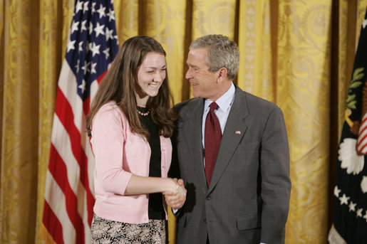 President George W. Bush congratulates Megan Larcom, 16, of Middletown High School in Middletown, R.I., on receiving the President’s Environmental Youth Award in the East Room of the White House April 21, 2005. White House photo by Paul Morse