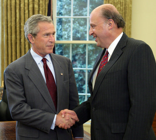 President George W. Bush offers congratulations to John Negroponte, Thursday, April 21, 2005, in the Oval Office after Mr. Negroponte was sworn in as the Director of National Intelligence. White House photo by Eric Draper