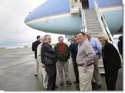 President George W. Bush shares a laugh with his congressional delegation Friday, April 22, 2005, after landing at McGhee Tyson Air National Guard Base in Knoxville. From left are Rep. John Duncan, Jr. (obstructed); Senator Lamar Alexander; Rep. Zach Wamp; Senator Bill Frist; Rep. William Jenkins; EPA Administrator Steve Johnson, and Interior Secretary Gale Norton.  White House photo by Eric Draper