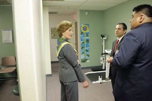 Dennis Huff, program director of the Native American Community Health Center, and Marcus Harrison, CEO of the Native American Community Health Center, give Laura Bush a tour of the Native American Community Health Center in Phoenix, Ariz., April 26, 2005. 