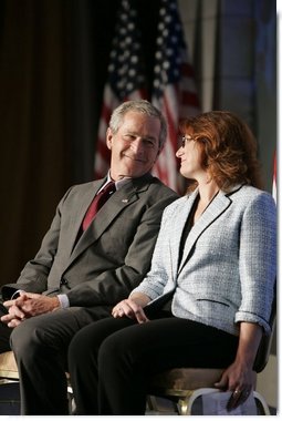 President George W. Bush shares the spotlight with Marianne Sensale-Guerin, 2005 SBA National Small Business Person of the Year, during his address to the National Small Business Week Conference in Washington, D.C., Wednesday, April 27, 2005.  White House photo by Paul Morse