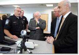 Vice President Dick Cheney, Senator Saxby Chambliss, and Department of Homeland Security Secretary Michael Chertoff listen as a U.S. Customs and Border Protection agent shows off some of the technology being used to train law enforcement personnel at the Federal Law Enforcement Training Center in Glynco, Georgia, May 2, 2005. The Vice President toured the facility, which provides training to more than 80 federal agencies, in addition to state and local police. The facility is the largest law enforcement training establishment in the country and graduates over 50,000 students annually.  White House photo by David Bohrer