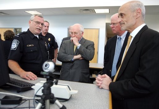 Vice President Dick Cheney, Senator Saxby Chambliss, and Department of Homeland Security Secretary Michael Chertoff listen as a U.S. Customs and Border Protection agent shows off some of the technology being used to train law enforcement personnel at the Federal Law Enforcement Training Center in Glynco, Georgia, May 2, 2005. The Vice President toured the facility, which provides training to more than 80 federal agencies, in addition to state and local police. The facility is the largest law enforcement training establishment in the country and graduates over 50,000 students annually. White House photo by David Bohrer