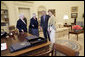 President George W. Bush and Laura Bush discuss some of the history of the Oval Office Agnes Chouteau, left, and Lorraine Stange both of Missouri Monday, May 2, 2005. The two women are recipients of the 2005 Preserve America Presidential Award. White House photo by Eric Draper