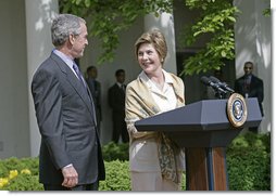 Laura Bush looks over to President Bush during a Rose Garden announcement honoring the 2005 Preserve America Presidential Awards Winners Monday, May 2, 2005. "These awards recognize collaborative efforts to protect and enhance our nation's cultural and historical heritage," said Mrs. Bush in her remarks. White House photo by Eric Draper