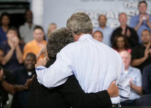 President George W. Bush hugs stage participant DeLois Killen Tuesday, May 3, 2005, at the end of a Conversation on Strengthening Social Security at the Nissan North America Manufacturing Plant in Canton, Miss. Mrs. Killen, a full-time dispatcher at the Union (Mississippi) Police Station, is not worried about losing her benefits -- which she relies on heavily -- but she believes that changes to Social Security are necessary. White House photo by Eric Draper