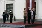 President George W. Bush and Laura Bush and Latvia President Vaira Vike-Freiberga and husband Imants Freibergs stand for the playing of the American national anthem Saturday, May 7, 2005, at Riga Castle in Riga, Latvia. White House photo by Eric Draper