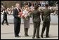 President George W. Bush and Latvia's President Vaira Vike-Freiberga participate in a wreath-laying ceremony in front of the Freedom Monument in Riga, May 7, 2005. White House photo by Paul Morse
