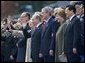 President George W. Bush and Laura Bush stand with Russian President Vladimir Putin and Lyudmila Putina, French President Jacque Chirac, far left, and Chinese President Hu Jintao, right, as many heads of state watch a parade in Moscow's Red Square commemorating the end of World War II Monday, May 9, 2005. White House photo by Eric Draper