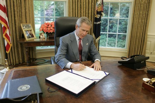 President George W. Bush signs into law H.R. 1268, the "Emergency Supplemental Appropriations Act for Defense, the Global War on Terror, and Tsunami Relief, 2005," Wednesday, May 11, 2005, in the Oval Office. The bill provides emergency supplemental appropriations for military operations, relief and reconstruction, and related activities critical to building stable democracies in Iraq and Afghanistan, as well as assisting those who suffered in the aftermath of the December 2004 tsunami in the Indian Ocean. White House photo by Paul Morse