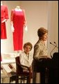 With former First Lady Nancy Reagan looking on, Laura Bush addresses the opening of The Heart Truth’s First Ladies Red Dress Collection Thursday, May 12, 2005, at the John F. Kennedy Center for the Performing Arts in Washington D.C. Mrs. Bush, the ambassador for The Heart Truth, wore her red Carolina Herrera suit to the Bolshoi Theater in Moscow and to The Heart Truth’s Red Dress Collection Fashion Show 2005 in New York City. White House photo by Krisanne Johnson