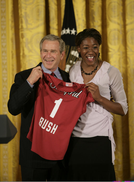 Ogonna Nnamani presents President George W. Bush with a team jersey from the Stanford University Women’s volleyball team during a ceremony celebrating the 2005 NCAA champions in the East Room Friday, May 13, 2005. White House photo by Eric Draper