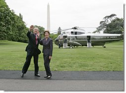 President George W. Bush and Laura Bush wave to the NCAA champions on the Truman balcony before departing the South Lawn en route Camp David Friday, May 13, 2005.  White House photo by Paul Morse