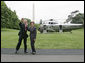 President George W. Bush and Laura Bush wave to the NCAA champions on the Truman balcony before departing the South Lawn en route Camp David Friday, May 13, 2005. White House photo by Paul Morse