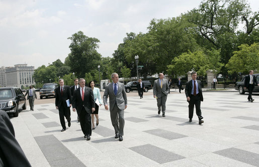 President George W. Bush walks along Pennsylvania Ave. as he leaves the White House for the nearby New Executive Office Building to attend the swearing-in ceremony for the National Intelligence Director Wednesday, May 18, 2005. White House photo by Eric Draper