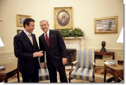 President George W. Bush talks with Prime Minister Anders Fogh Rasmussen of Denmark in the Oval Office Friday, May 20, 2005. White House photo by Eric Draper