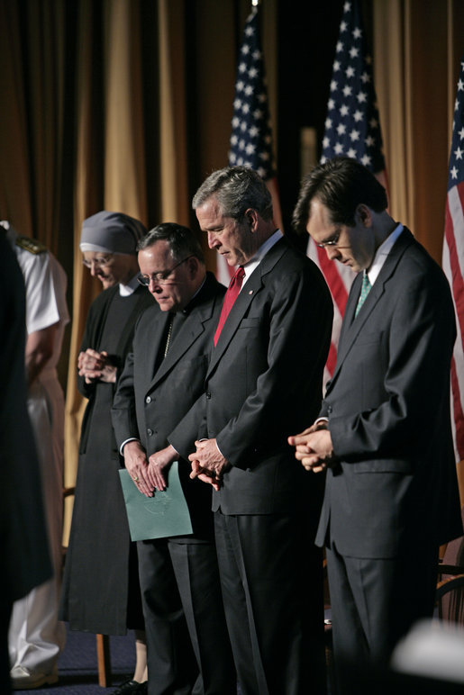 President George W. Bush joins his hosts in prayer while attending the National Catholic Prayer Breakfast in Washington, D.C., Friday, May 20, 2005. White House photo by Eric Draper