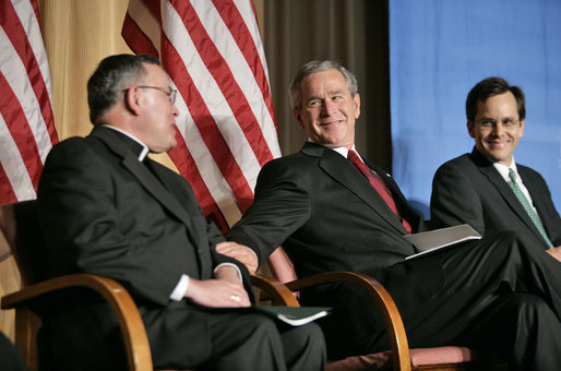 President George W. Bush reaches to Archbishop Charles J Chaput of Denver at the National Catholic Prayer Breakfast in Washington, D.C., Friday, May 20, 2005. Also pictured is Joseph Cella. White House photo by Eric Draper