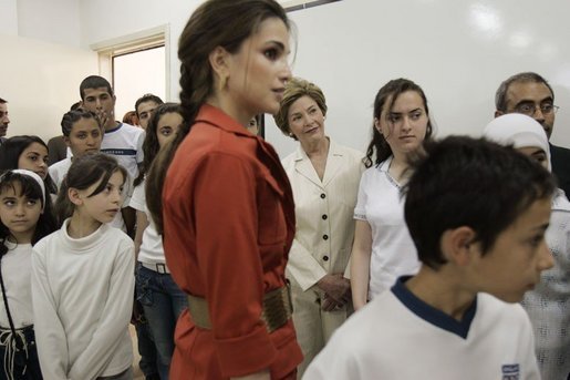 Queen Raina Al-Abdullah, wife of King Abdullah of Jordan, center, and Laura Bush listen to a computer lab presentation at the Discovery School of Swaifiyeh Secondary School in Amman, Jordan, Sunday, May 22, 2005. The school is one of 100 in the country that have developed Internet curriculum to help reform Jordanian education. White House photo by Krisanne Johnson