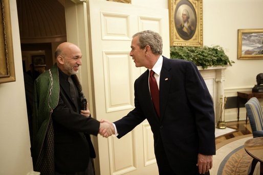 President George W. Bush welcomes Afghanistan President Hamid Karzai into the Oval Office Monday, May 23, 2005, following his arrival to the White House. White House photo by Eric Draper
