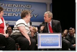 President George W. Bush talks with a fellow stage participant during a conversation about strengthening Social Security at Greece Athena Middle and High School in Greece, N.Y., Tuesday, May 24, 2005.  White House photo by Paul Morse