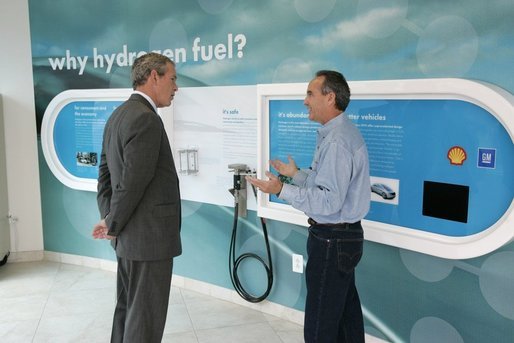 President George W. Bush is led by Rick Scott, Operations and Safety Coordinator, Shell Hydrogen, L.L.C., through the visitor center exhibit at a Washington D.C. Shell Service Station equipped with a hydrogen fueling station Wednesday, May 25, 2005. The station is the first integrated gasoline/hydrogen station in North America and will service a fleet of six GM fuel cell vehicles, which were developed in collaboration with the Department of Energy. White House photo by Paul Morse