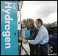 With the help of Rick Scott, Operations and Safety Coordinator, Shell Hydrogen, L.L.C., President George W. Bush replaces a nozzle on a hydrogen fueling pump at a Shell station in Washington D.C. The President visited the station, the first integrated gasoline/hydrogen station in North America, Wednesday, May 25, 2005, for a demonstration of its functions. White House photo by Paul Morse
