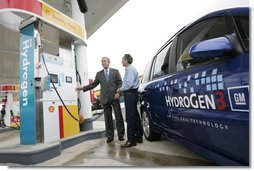 President George W. Bush talks to the media as he stands with Rick Scott, Operations and Safety Coordinator, Shell Hydrogen, L.L.C., Wednesday, May 25, 2005, at a Washington D.C. Shell Station, the first integrated gasoline/hydrogen station in North America.  White House photo by Paul Morse