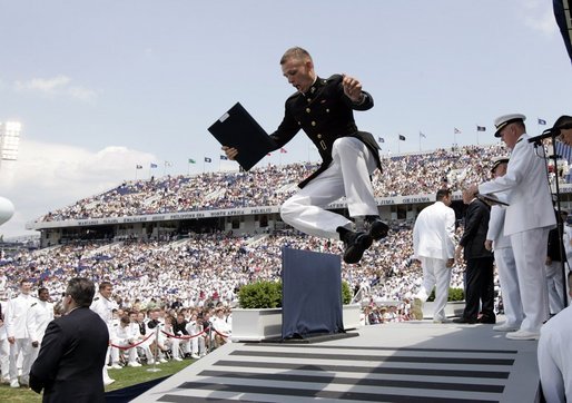 A U.S. Naval Academy graduate celebrates after receiving his diploma in Annapolis, Md., Friday, May 27, 2005. White House photo by Paul Morse