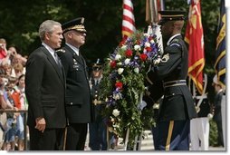 President George. W. Bush stands with U.S. Army Major General Galen Jackman as he lays a wreath at the Tomb of the Unknown Soldier at the Arlington National Cemetery on Memorial Day May 30, 2005.  White House photo by Krisanne Johnson