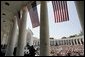 Thousands of people gather to pay their respects on Memorial Day at the amphitheatre in Arlington National Cemetery in Arlington, Va., May 30, 2005. White House photo by Paul Morse