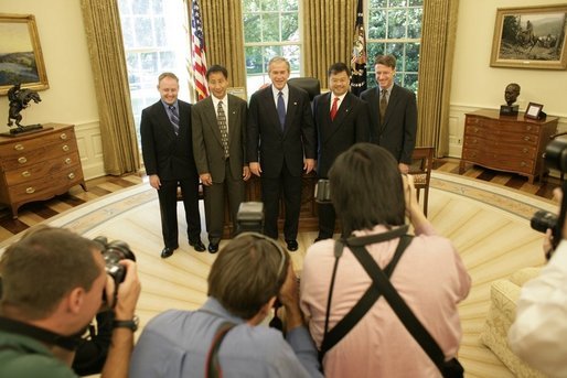 President George W. Bush welcomed the crew members and families of the International Space Station expeditions 7, 8, 9 and 10 to the Oval Office Tuesday, May 31, 2005. Standing for photos with the President from left are: Lt. Colonel Mike Fincke, ISS 9; Dr. Edward Lu, ISS 7; Dr. Leroy Chiao, ISS 10, and Dr. Michael Foale, ISS 8. White House photo by Eric Draper
