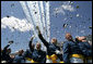 Graduates toss their hats into the air as the contrails from five F-16's stream overhead during the U.S. Air Force Academy graduation in Colorado on Wednesday, June 1, 2005. Nine-hundred and six graduates became commissioned officers in the U.S. Air Force after their four-year curriculum that began shortly before Sept. 11, 2001. White House photo by David Bohrer
