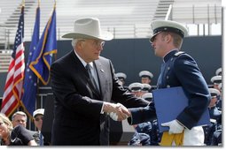 Vice President Dick Cheney shakes hands with Andrew Sellers, the first graduate to receive his diploma in the U.S. Air Force Academy Class of 2005, during the commencement ceremony in Colorado on Wednesday, June 1, 2005. The graduate was deemed the outstanding cadet for academic performance, military performance and in the field of computer science. White House photo by David Bohrer