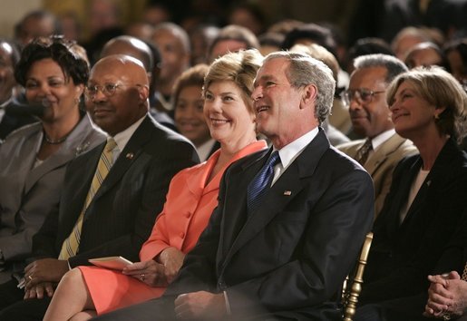 President George W. Bush, Laura Bush and HUD Secretary Alphonso Jackson, pictured at right, listen to performers during the White House reception honoring June as Black Music Month in the East Room Monday, June 6, 2005. White House photo by Paul Morse