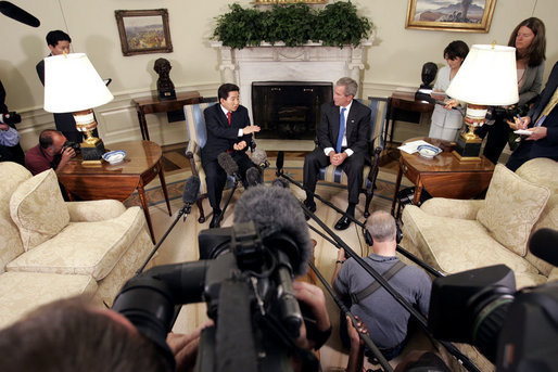 President George W. Bush and South Korean President Roh Moo-hyun talk with the press in the Oval Office Friday, June 10, 2005. White House photo by Paul Morse