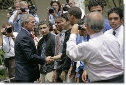 President George W. Bush greets some of the 200 exchange students he addressed in the Rose Garden Monday, June 13, 2005. Living with host families in America for one year, students from the many Muslim countries participate in the State Department program, Partnerships for Learning, Youth Exchange and Study. White House photo by Eric Draper