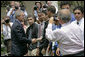 President George W. Bush greets some of the 200 exchange students he addressed in the Rose Garden Monday, June 13, 2005. Living with host families in America for one year, students from the many Muslim countries participate in the State Department program, Partnerships for Learning, Youth Exchange and Study. White House photo by Eric Draper