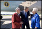 President George W. Bush talks with John and Agnes Jurek in front of Air Force One in Minneapolis Friday, June 17, 2005. The Jureks are volunteers with the Retired and Senior Volunteer Program (RSVP). They each have logged more than 4,000 hours since volunteering at the Veterans Affairs Medical Center in Minneapolis 16 years ago. White House photo by Eric Draper