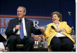 President George W. Bush and Dorothy Bourgeois share a light moment together on stage Friday, June 17, 2005, during a Conversation on Medicare in Maple Grove Minn. White House photo by Eric Draper