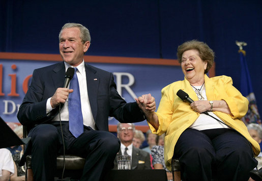 President George W. Bush and Dorothy Bourgeois share a light moment together on stage Friday, June 17, 2005, during a Conversation on Medicare in Maple Grove Minn. White House photo by Eric Draper