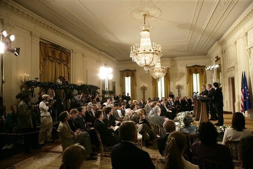 The media crowds into the East Room of the White House Monday, June 20, 2005, as President George W. Bush, European Union President Jean-Claude Juncker, left, and European Commission President Jose Manuel Barroso hold a joint press conference. White House photo by Eric Draper