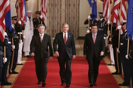 President George W. Bush leads European Union President Jean-Claude Juncker, left, and European Commission President Jose Manuel Barroso as they head to a joint press availability in the East Room Monday, June 20, 2005. White House photo by Paul Morse