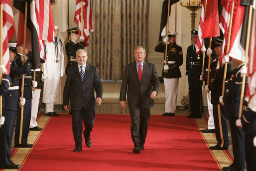 President George W. Bush walks with Dr. Ibrahim Jaafari, Prime Minister of Iraq, toward the East Room Friday, June 24, 2005, to meet the media. White House photo by Paul Morse