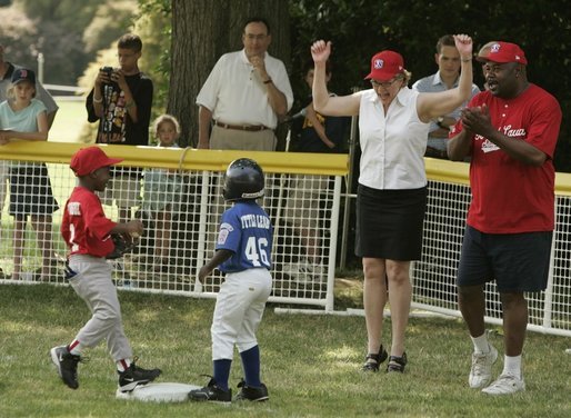 Secretary of Education Margaret Spellings is on her toes as she declares safe at first Naji Loggins of the Newark (New Jersey) Black Yankees after Naji singled during "Tee Ball on the South Lawn." White House photo by Paul Morse