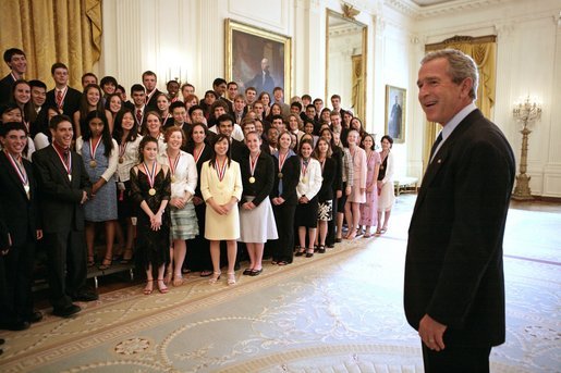 President George W. Bush greets the 2005 Presidential Scholars during a group photo shoot in the East Room June 27, 2005. Chosen from more than 2,700 high school candidates, 141 scholars are honored for their accomplishments in academics and the arts. White House photo by Eric Draper