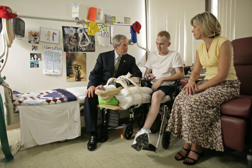 President George W. Bush talks with U.S. Army Specialist Nicholas Beintema and his mother Stacy Beintema of Woodbridge, Calif., while visiting wounded troops at Walter Reed Army Medical Hospital Friday, July 1, 2005. Spc. Beintema was wounded while serving in Operation Iraqi Freedom. White House photo by Eric Draper