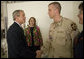 President George W. Bush shakes the hand of Capt. Daniel Gade, a double Purple Heart recipient, during the President's visit Friday, July 1, 2005, to Walter Reed Army Medical Center. The Minot, North Dakota soldier is recovering from injuries sustained during Operation Iraqi Freedom. In the background is his wife, Wendy. White House photo by Eric Draper