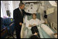 President George W. Bush spends a moment with Cpl. Cole Hansen of Canby, Minn., during a visit to Walter Reed Army Medical Center Friday, July 1, 2005. Cpl. Hansen is recovering from wounds received while serving in Operation Iraqi Freedom. White House photo by Eric Draper